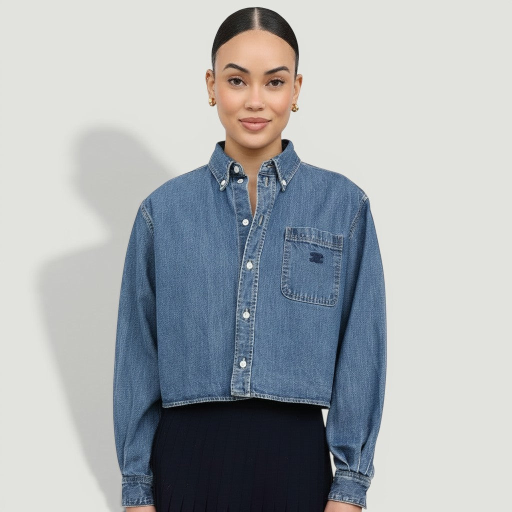 Model wearing a La Volta CELINE cropped denim shirt in union ocean wash with Triomphe embroidery and button-up front.