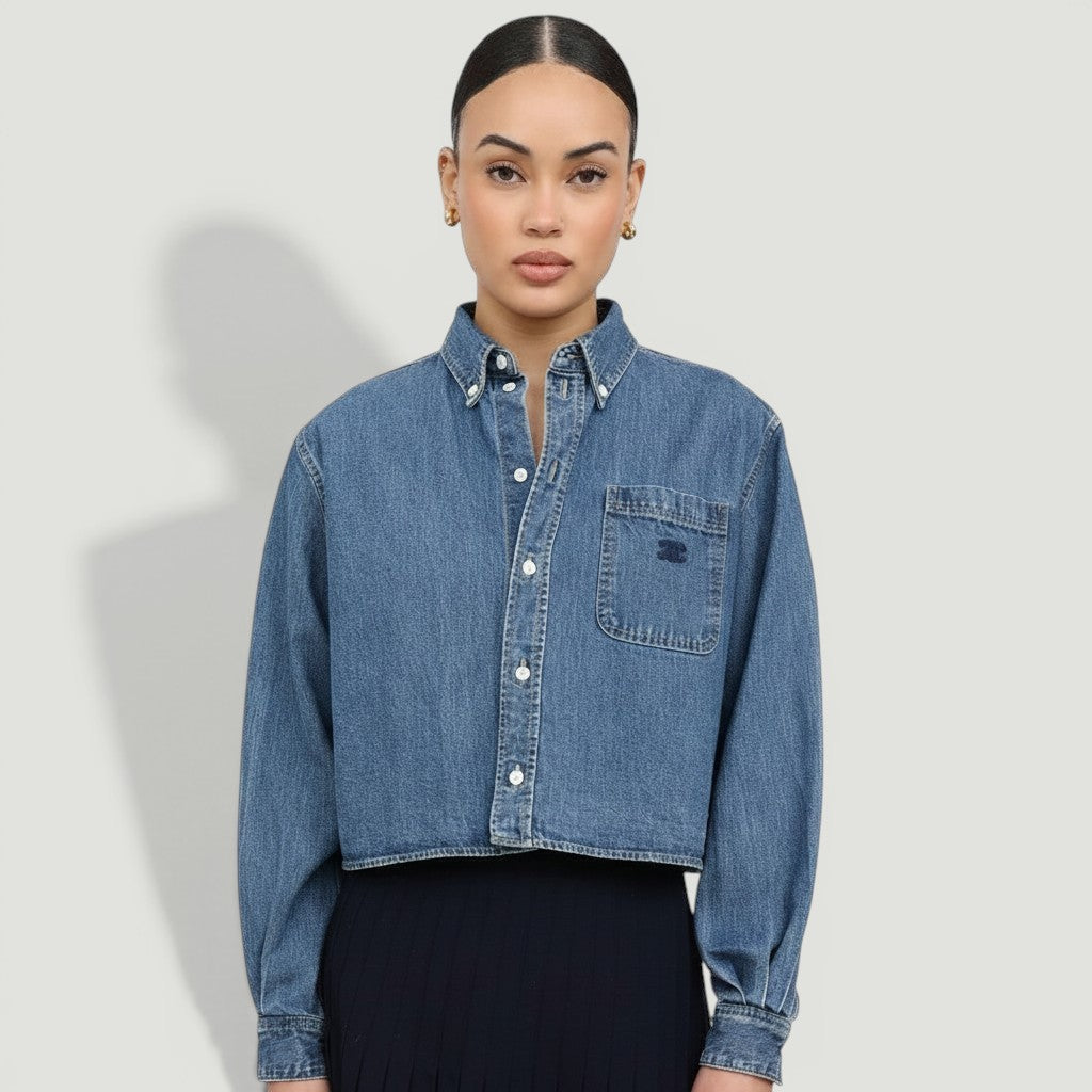 Model wearing a La Volta CELINE cropped denim shirt in union ocean wash with Triomphe embroidery and button-up front.