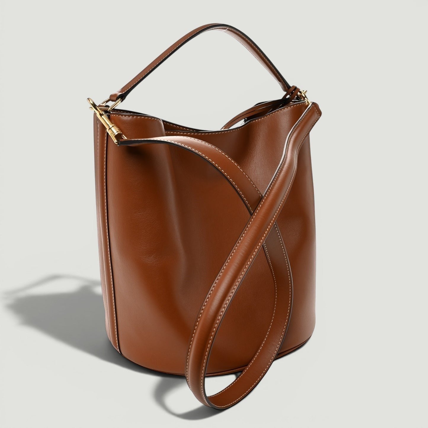 La Volta CELINE tan smooth calfskin leather bucket 16 bag with gold hardware, top handle, and shoulder strap.