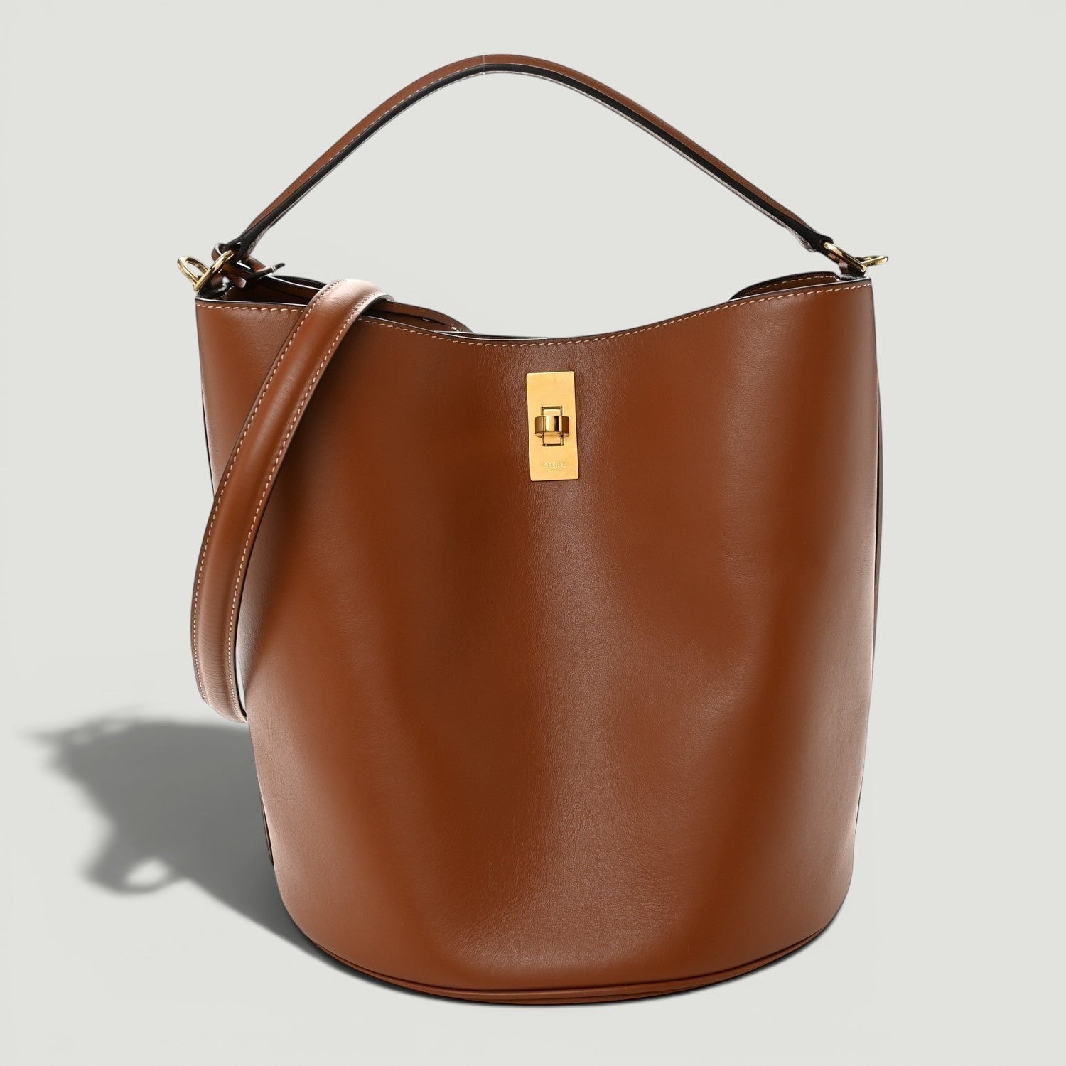 La Volta CELINE tan smooth calfskin leather bucket 16 bag with gold hardware, top handle, and shoulder strap.