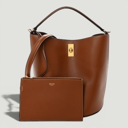 La Volta CELINE tan smooth calfskin Bucket 16 bag with gold hardware, top handle, and matching leather pouch.