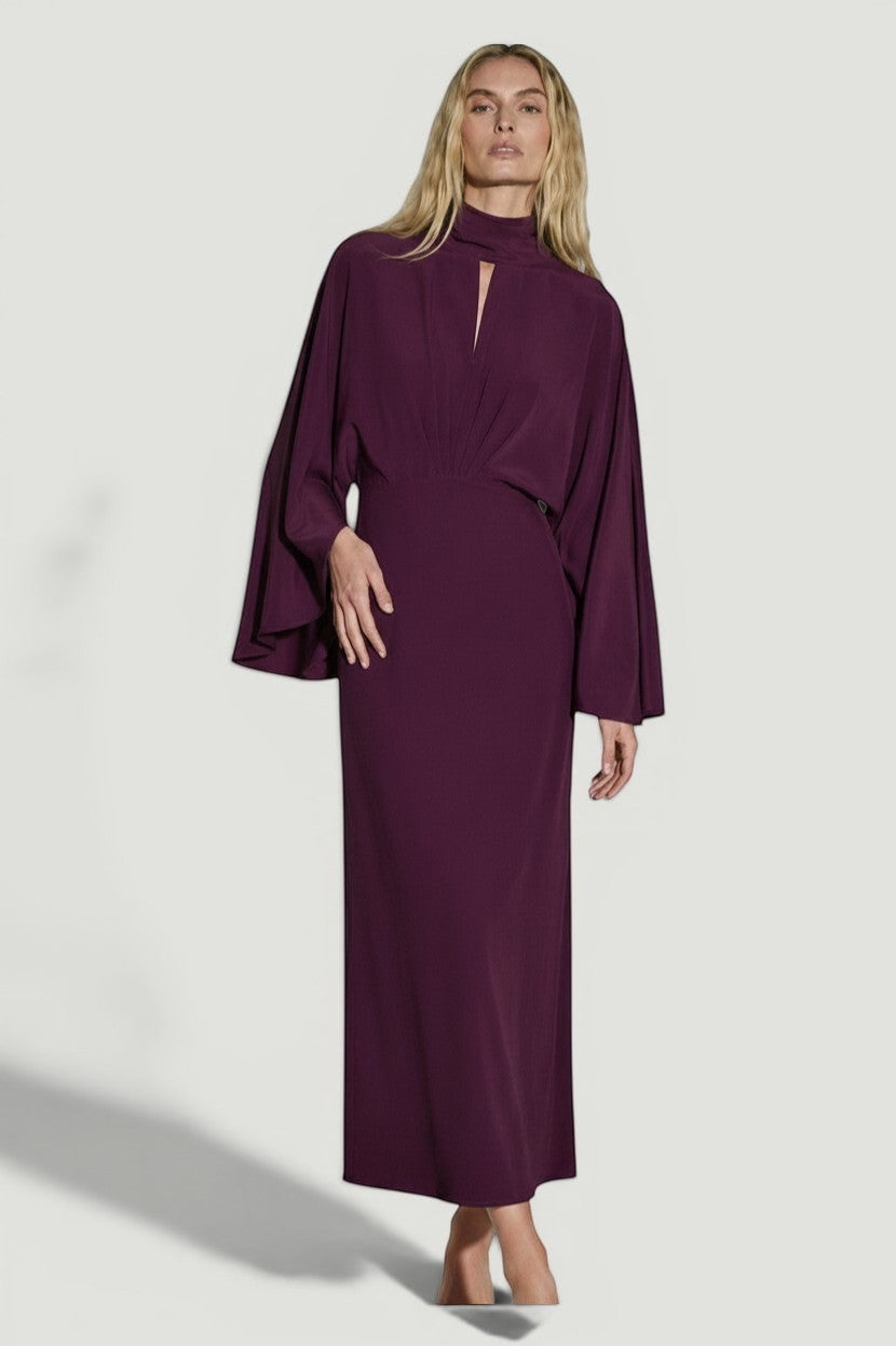 La Volta Johanna Ortiz burgundy ankle-length dress with cape-style sleeves and a high neckline on a model.