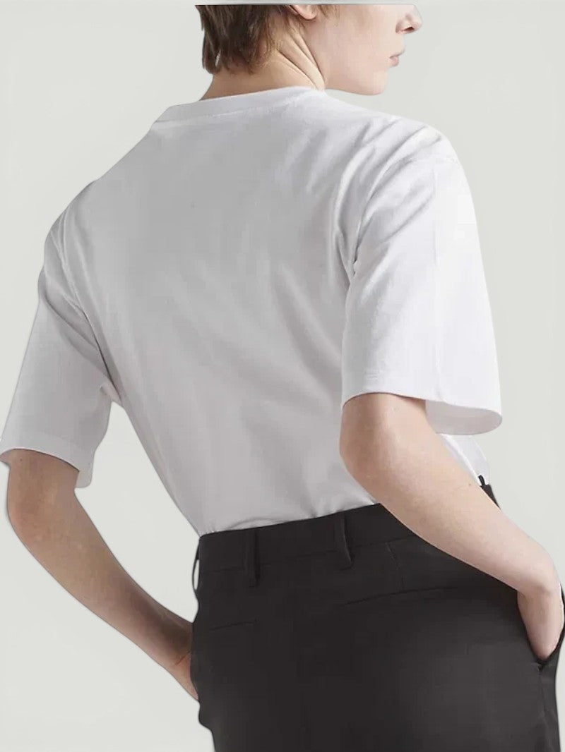 La Volta model wearing a white Prada round neck t-shirt with short sleeves, viewed from the back.