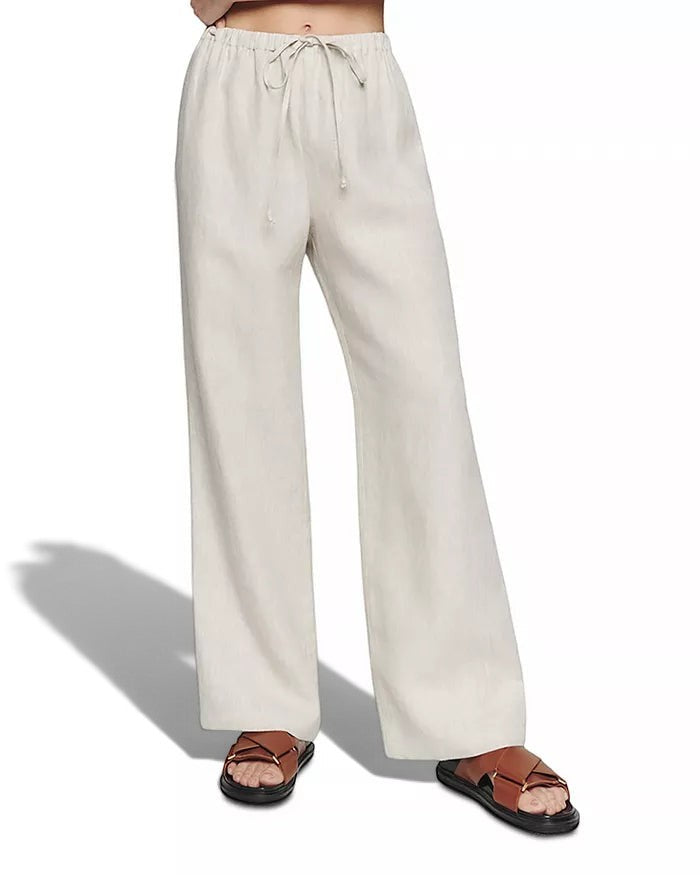 La Volta Reformation oatmeal linen pants with a drawstring waist and relaxed fit leg on a model