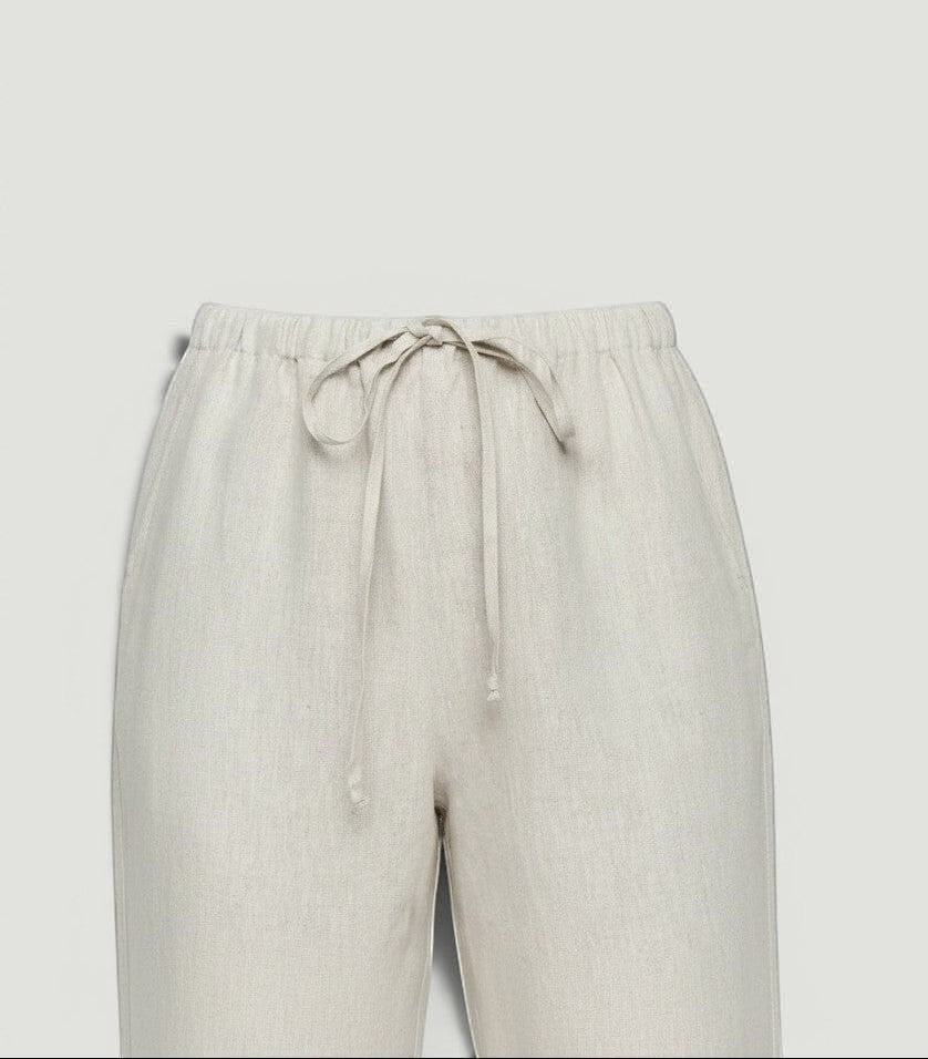 La Volta Reformation oatmeal linen pants featuring a comfortable elastic drawstring waist in a relaxed fit style.