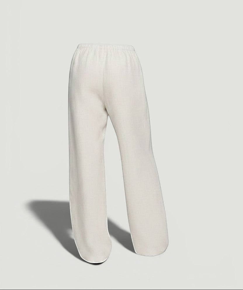 La Volta Reformation oatmeal linen pants with a relaxed leg and drawstring waist, back view.