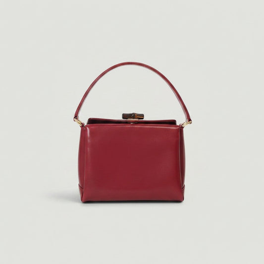 Vintage red calf leather Gucci top handle bag with bamboo twist lock closure, available at La Volta.